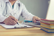 Male medicine doctor hand holding silver pen writing something on clipboard closeup. Medical care, insurance, prescription, paper work or career concept. Physician ready to examine patient and help