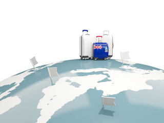 Luggage with flag of falkland islands. Three bags on top of globe