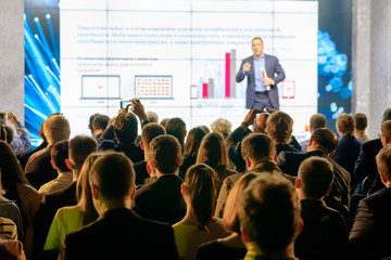 audience listens to the lecturer at the conference hall