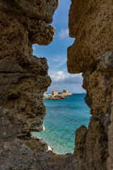 Poster - Agios Nikolaos Fortress (Fort of Saint Nicholas) and mills at Rhodes old town, view through medieval window, Rhodes island, Greece