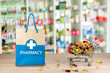 Recycled paper bag with a blue Pharmacy logo on a drugstore counter with pharmacy background shelf blurred blur focus drug medical shop drugstore medication background