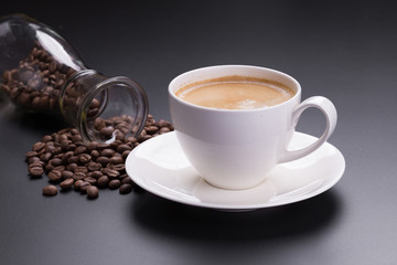 Hot americano coffee in white glass on black background