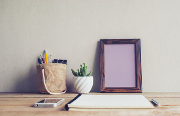 mock up blank photo frame with cactus flower on desk.