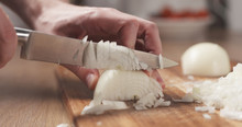 Man Cutting White Onion With Knife