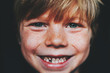 © RooM The Agency - Portrait of a cute gap toothed smiling boy with freckles