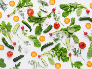 Wall Mural - Fresh vegetables and greens on a white background. Pattern of vegetables. Radish, carrots, tomatoes, cucumbers, dill isolated on white background. Vegetable background.