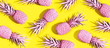 Leinwandbild Motiv Pink painted pineapples on a vivid yellow background