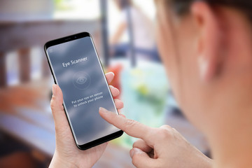 Poster - Biometric security with eye scanner app on mobile phone. Modern mobile in woman hand.