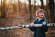 © RooM The Agency - Boy carrying piece of birch wood in forest