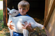 © RooM The Agency - Boy hugging a goat on homestead
