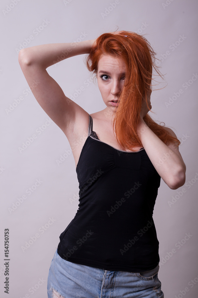sexy-busty-redheand-woman-in-studio-photo-on-gray-background-sexuality