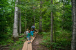 © RooM The Agency - Father with four children hiking through a trail in the woods