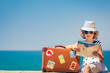 © Sunny studio - Child with vintage suitcase on summer vacation