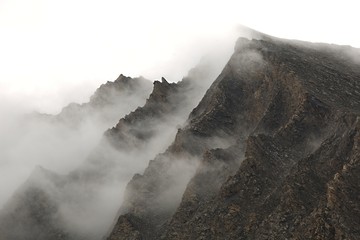 Canvas Print - Mountain cliffs in fog