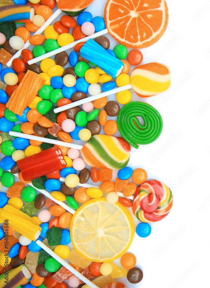 Tasty lollipops and colorful candies on white background