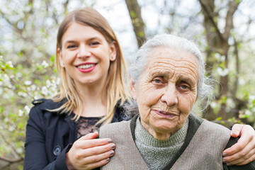 Canvas Print - Elderly woman with her carer outdoor