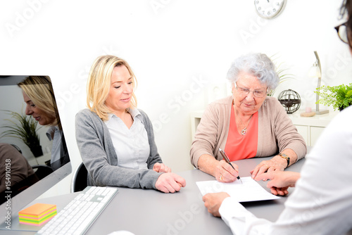 Fotomural elderly senior woman with daughter signature legacy heritage testament document