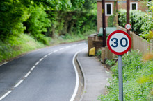 Speed Limit Sign On Side Of Road In UK