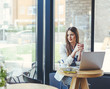 © LStockStudio - Young Businesswoman Sitting in Coffee Shop