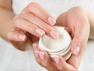 beautiful woman hands with cream