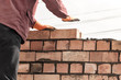 © schankz - Worker builds a brick wall in the house