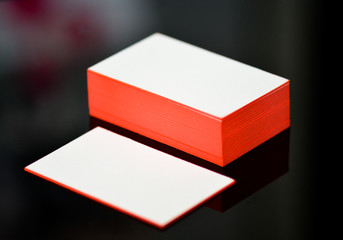 thick white cotton paper business card mock up with red painted edges. Blank business cards template.