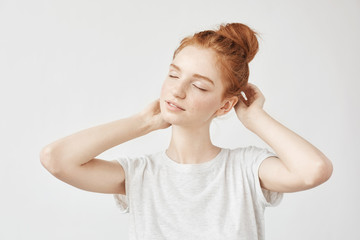 Wall Mural - Portrait of tender redhead girl smiling with closed eyes.