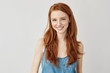 © Cookie Studio - Happy cheerful ginger girl smiling looking at camera.