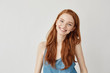 © Cookie Studio - Happy cheerful ginger girl smiling looking at camera.