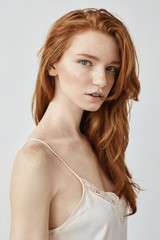 Fashion portrait of beautiful natural redhead girl looking at camera.