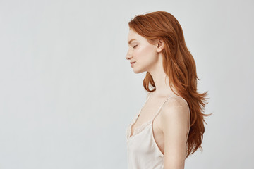 Sticker - Portrait of redhead girl in profile with closed eyes smiling.