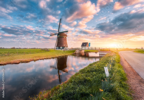 Windmill near the water canal at sunrise in Netherlands Canvas