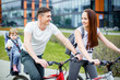 © Artem - Young parents ride a bicycle with a small daughter on city streets
