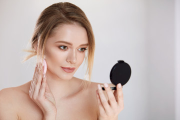 Face Make-Up. Female With Mirror Putting Cosmetic Powder