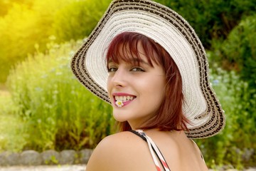 Wall Mural - Portrait of a beautiful girl with summer hat