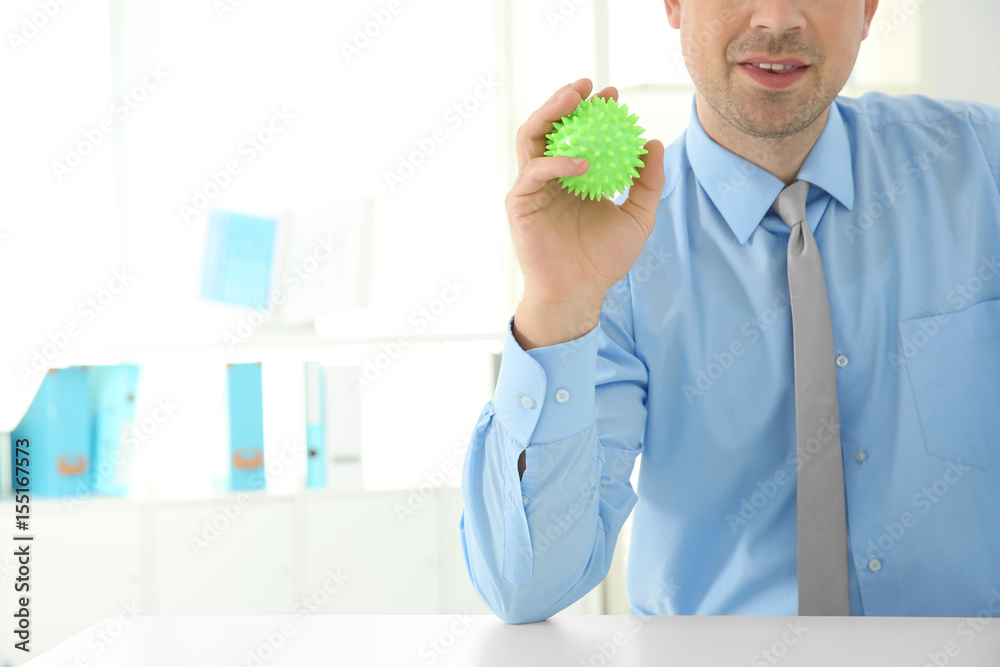 Man with stress ball in office