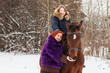© keleny - Teenager girl, mom and horse in a winter