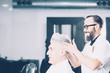 © click_and_photo - Cheerful barber working with client