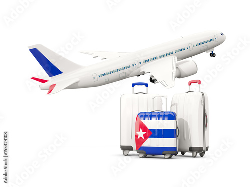 Luggage with flag of cuba. Three bags with airplane Canvas Print