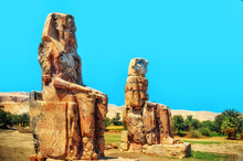 Egypt. Luxor. The Colossi Of Memnon - Two Massive Stone Statues Of Pharaoh Amenhotep III