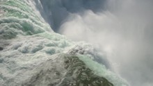 AERIAL CLOSE UP Flying Above Scenic Niagara Falls Along The Edge Of A Wall. Whitewater Rapids Breaking And Crushing Into The Bottom Of The Waterfall. Thick Fresh Mist Rising Above The Horseshoe Falls