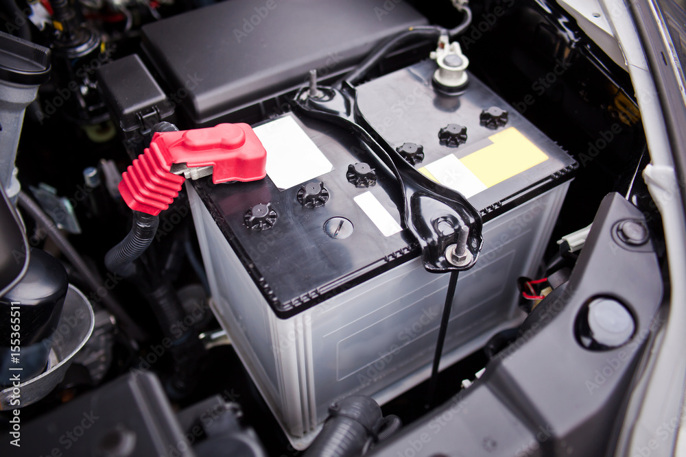 Battery installed near the V8 motor in SUV - obrazy, fototapety, plakaty 