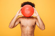 © Drobot Dean - Portrait of an afro american man covering face with frisbee
