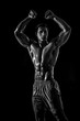 © nazarovsergey - Muscular and fit young bodybuilder fitness male model posing ove