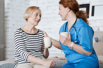 Wall Mural - Adorable senior woman thanking her doctor