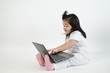 © Pixza - Asian child playing on computer laptop
