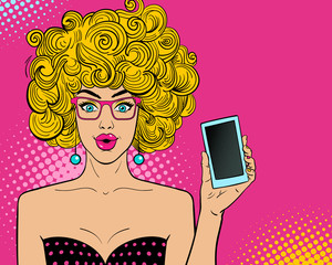 Wall Mural - Wow pop art female face. Sexy surprised young woman in glasses with open mouth and blonde hair holding smart phone in her hand. Vector bright background in pop art retro comic style.
