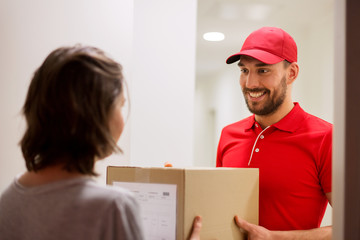 happy delivery man giving parcel box to customer