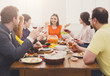 © Prostock-studio - Group of happy people at festive table dinner party
