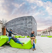 © EdNurg - Group of friends having fun and sitting on the bench at park in Vienna